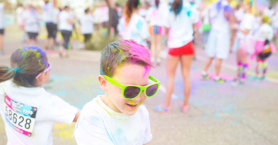 Kids with dyed hair at a fun run show the range of activities available to peer to peer fundraisers in 2025.