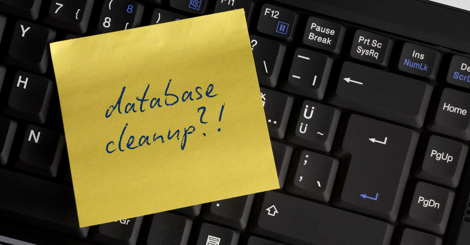 A post-it shows a handwritten phrase "database cleanup??!" as a reminder for data cleanliness.