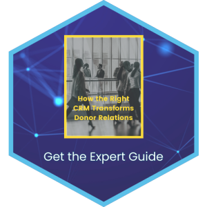 Hexagonal graphic with a central image of people walking in a modern hallway. Text reads “How the Right CRM Transforms Donor Relations.” The hexagon’s border contains the text “Get the Expert Guide” on a geometric blue background.