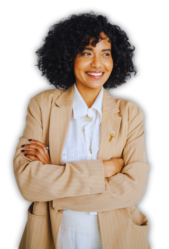 A woman with curly hair wearing a beige blazer and white shirt smiles and stands with her arms crossed against a white background, representing Heller Consulting Donor Data Hub for nonprofit identity resolution.