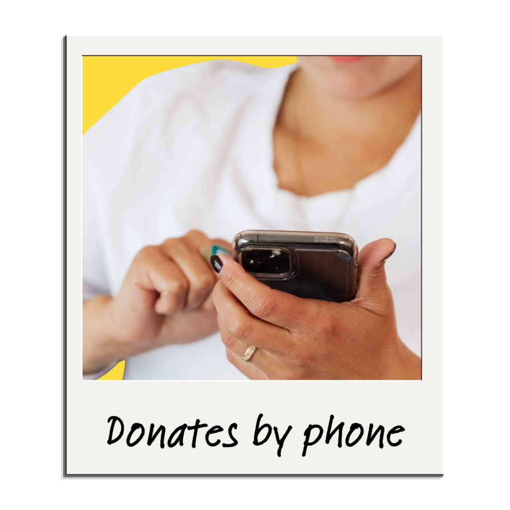 A person holds a smartphone and taps the screen, appearing to make a donation by phone. The image has a yellow background and the caption reads, Donates by phone using Heller Consulting Donor Data Hub for nonprofit identity resolution.